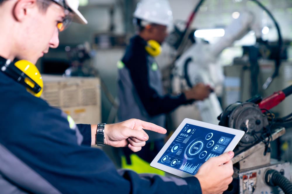 Engineers using data analytics in manufacturing to optimize production processes