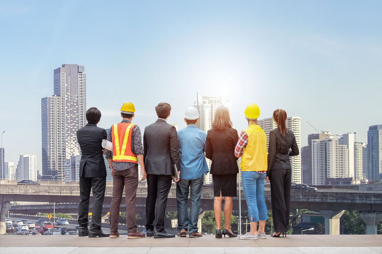 Contingent workers on a rooftop, looking at the city, symbolizing collaboration and future vision.