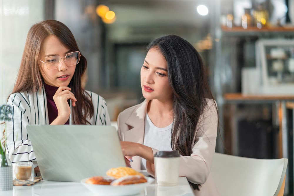 Office workers in recruitment process outsourcing service, brightly lit office
