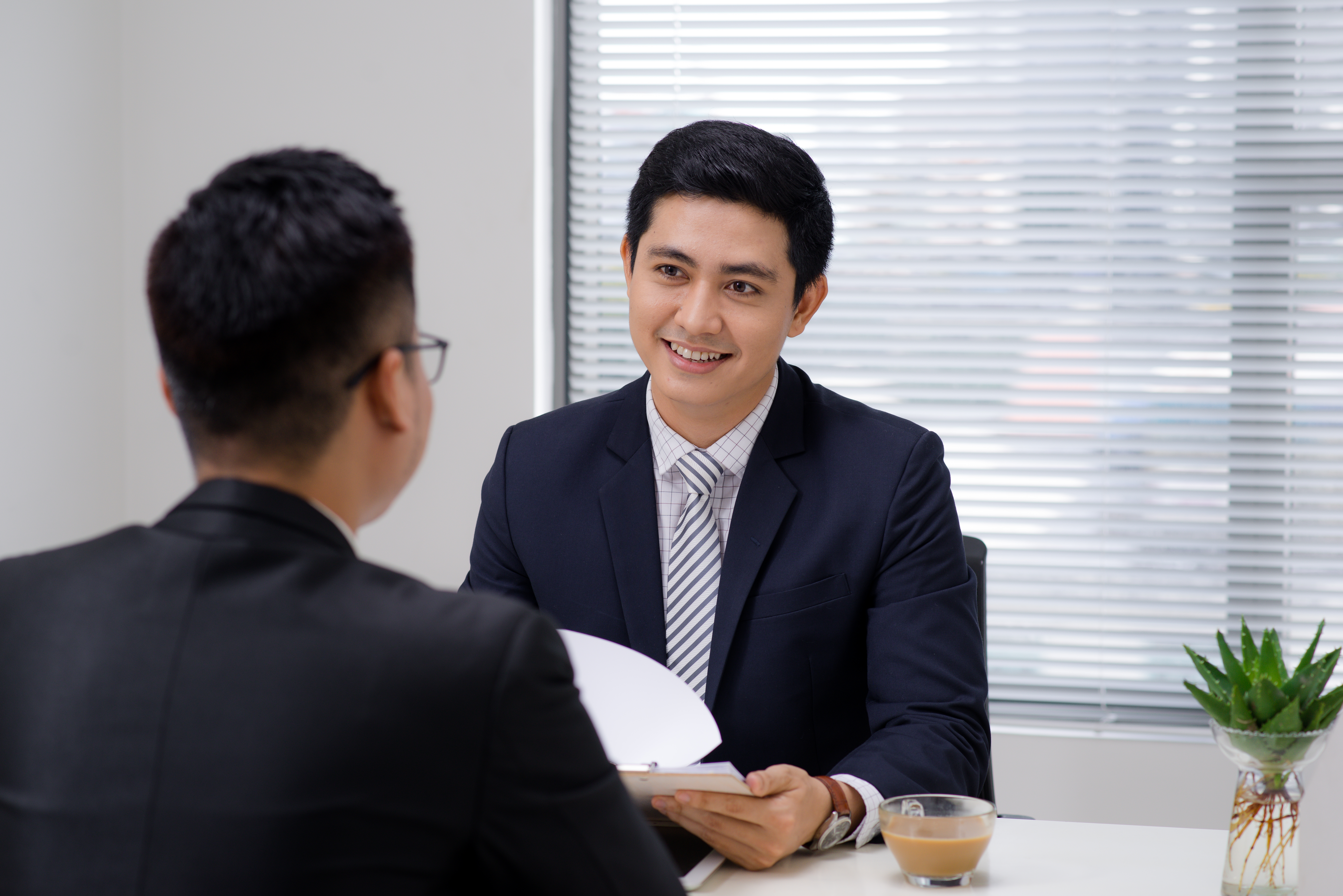 A candidate with a strong cover letter attending an interview for a Recruitment Consultant position.