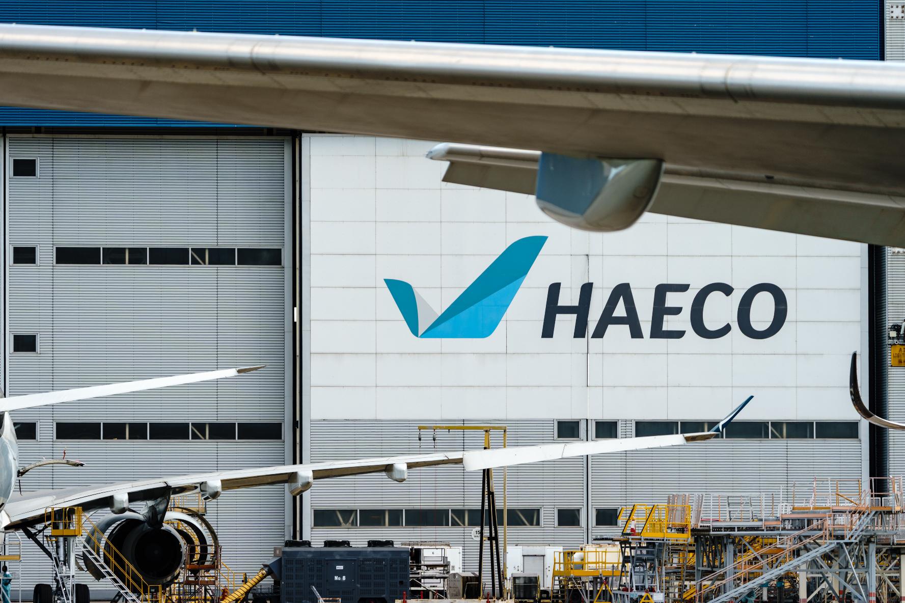 HAECO name and logo at a hangar with airplanes