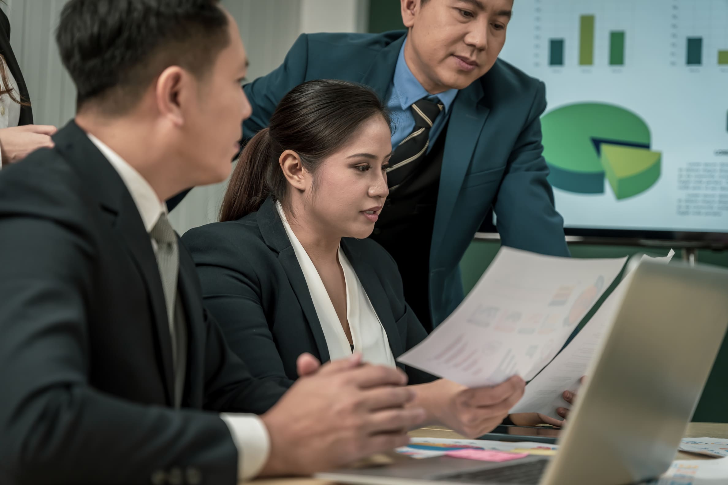Compliance managers reviewing global workforce governance standards and risk audit files
