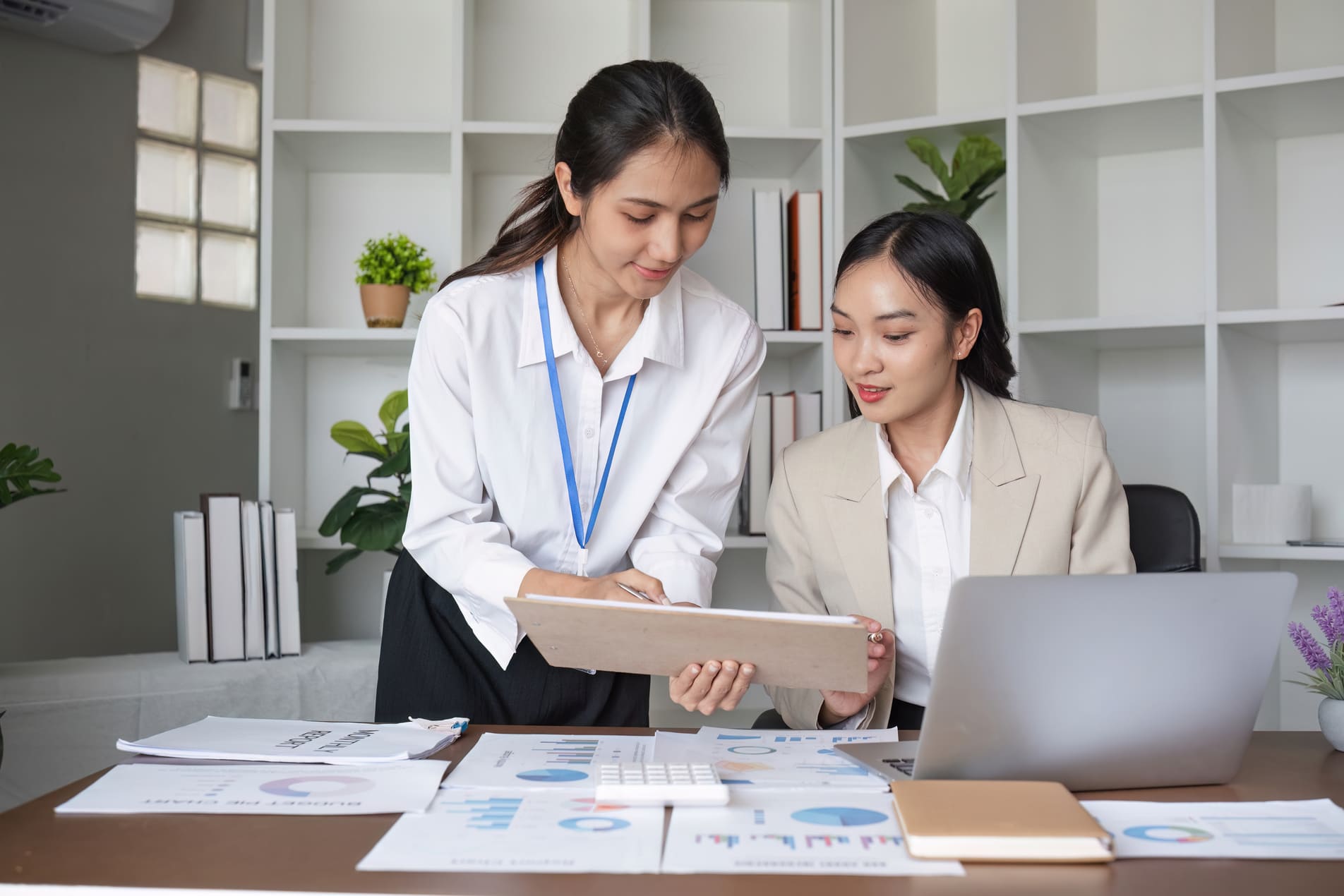 Financial controller and HR manager reviewing payroll budgets and workforce working-capital capacity