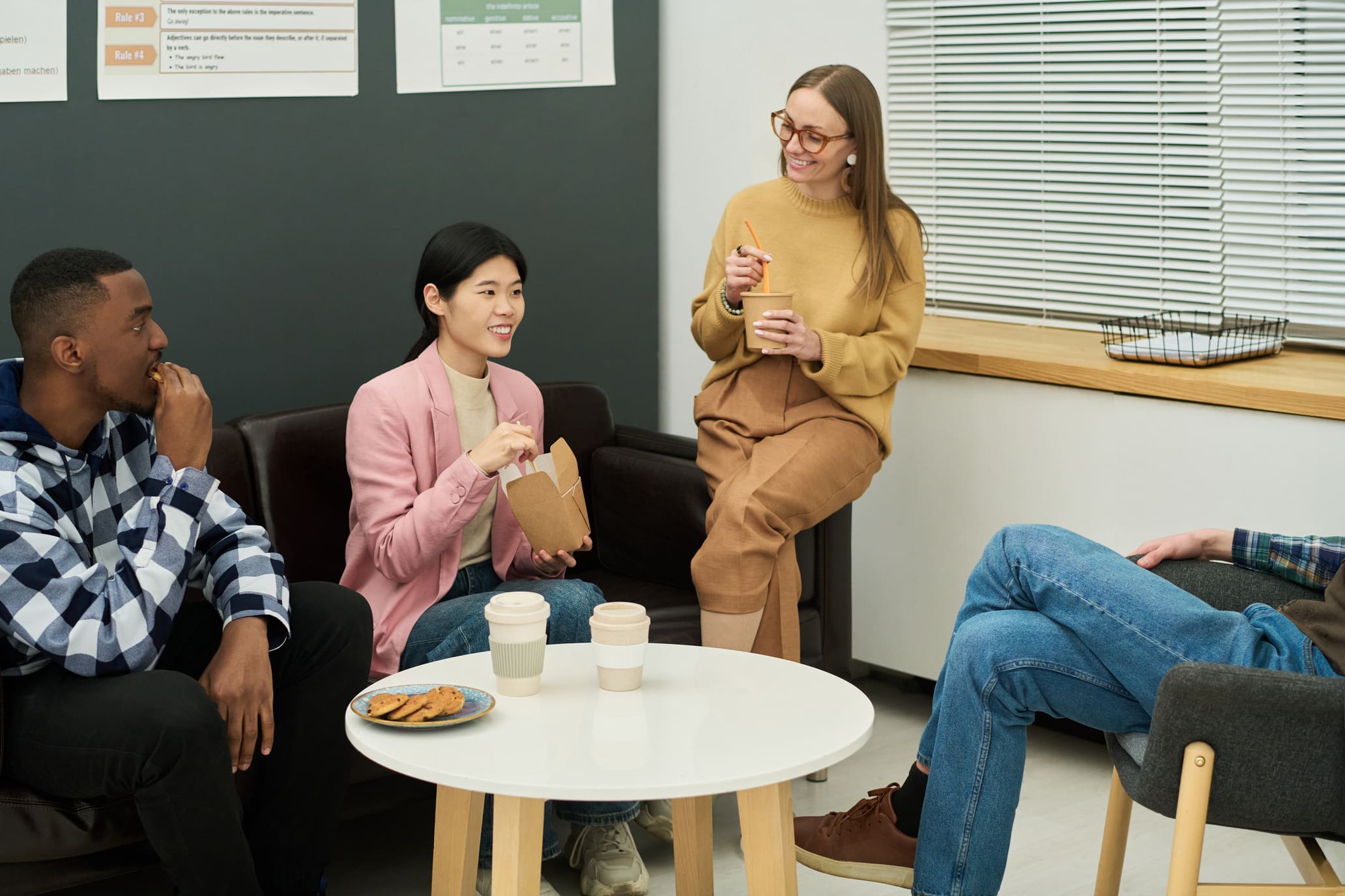 Employees chatting informally during a break in an office lounge area