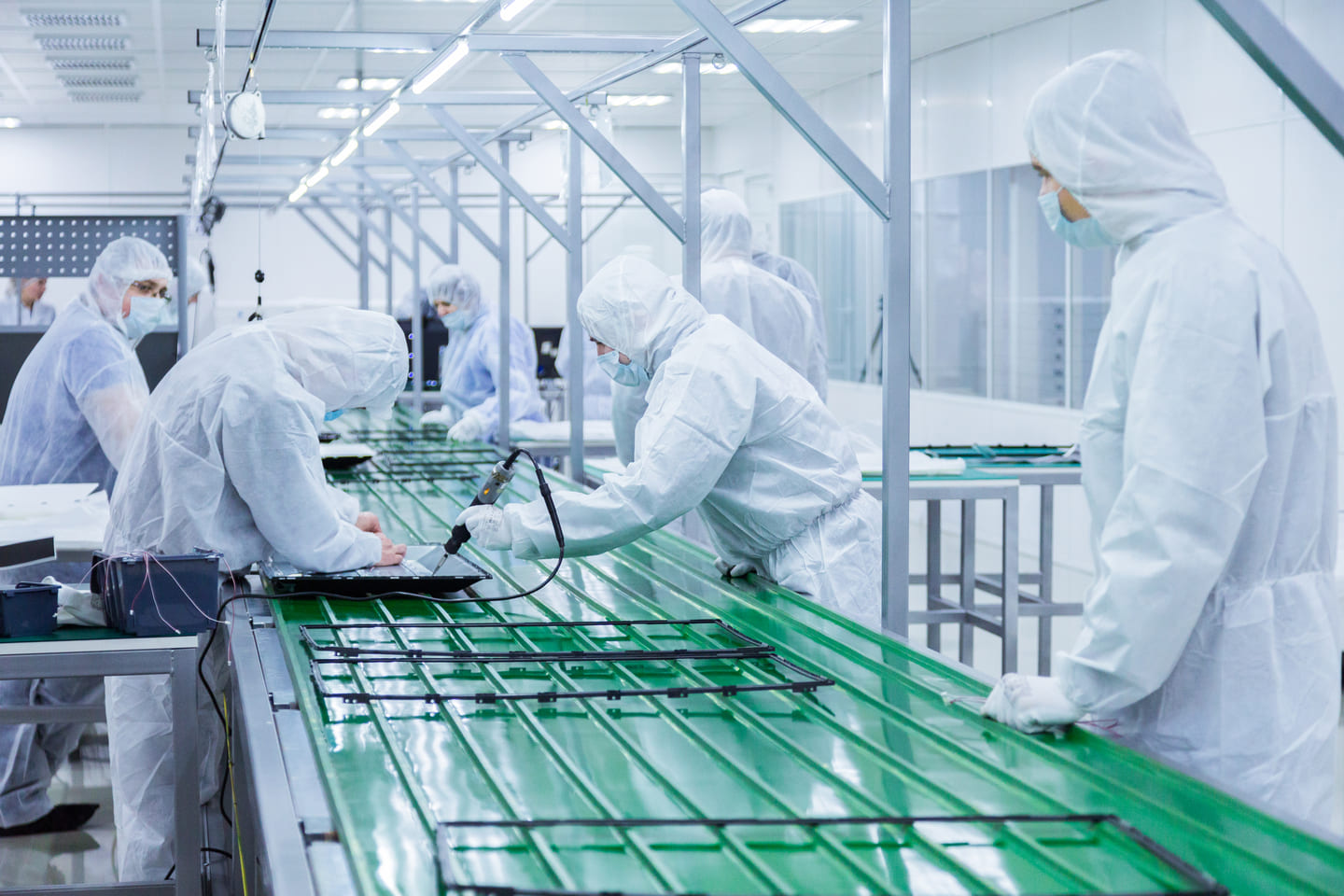 Stable team of manufacturing employees working together on a high-tech assembly line