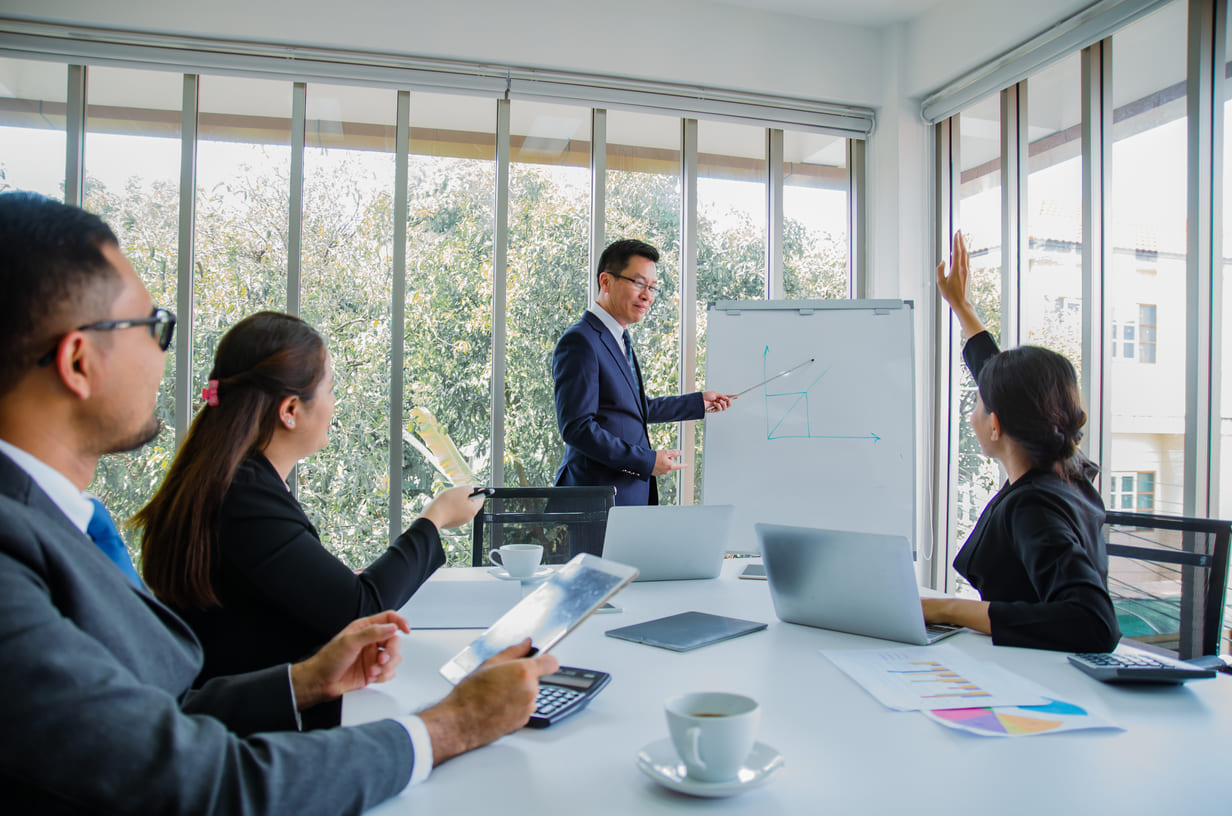 Corporate executives and staffing account managers conducting a quarterly KPI review meeting