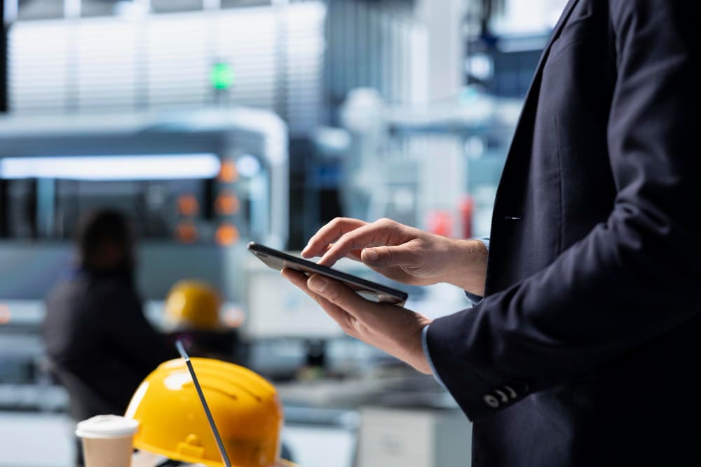 Factory supervisor assessing a new worker's role readiness on a manufacturing floor