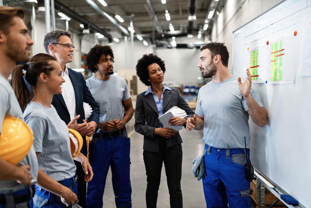 Factory orientation trainer teaching newly hired workers in a training room