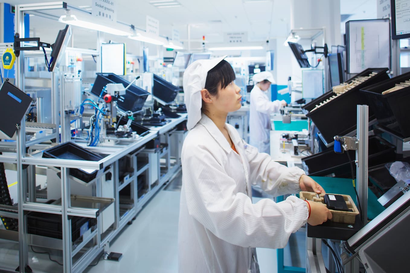 Skilled assembly line operators managing product manufacturing during high demand