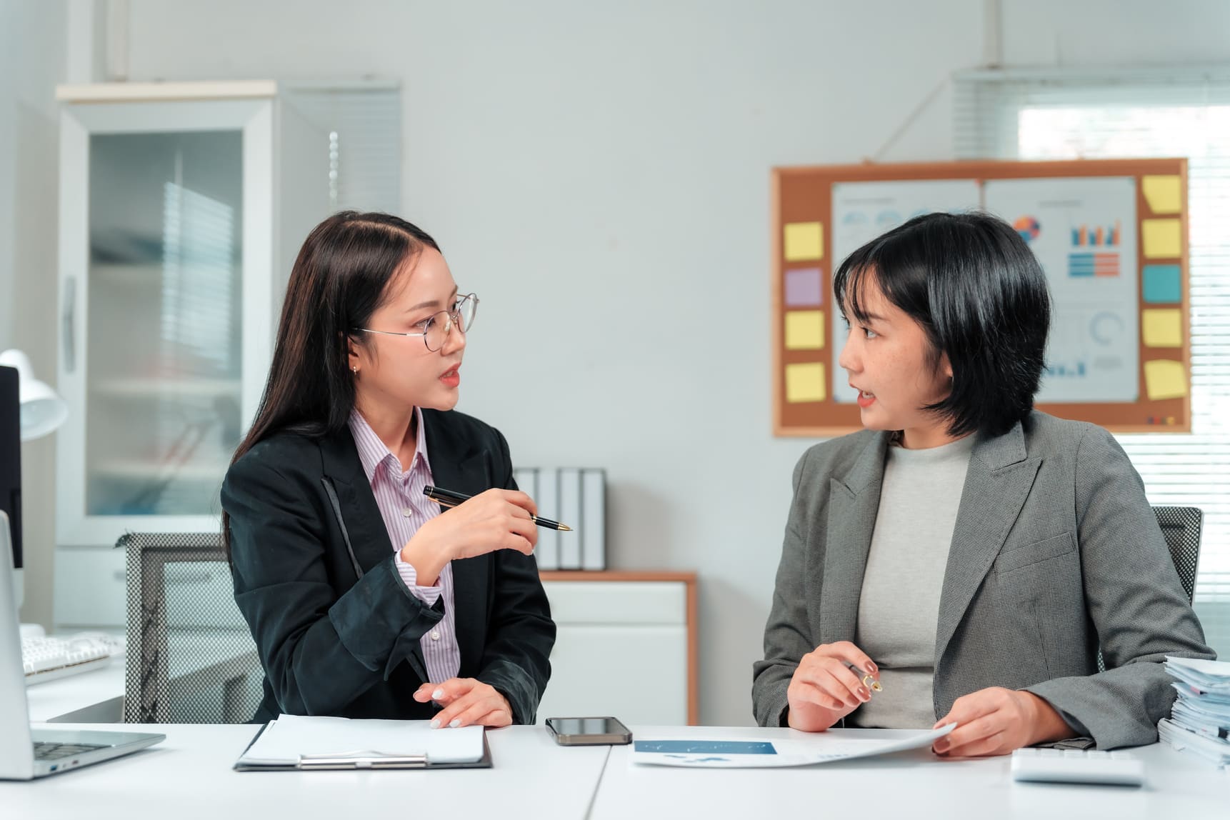 Operations supervisor and HR partner discussing workforce escalation protocols