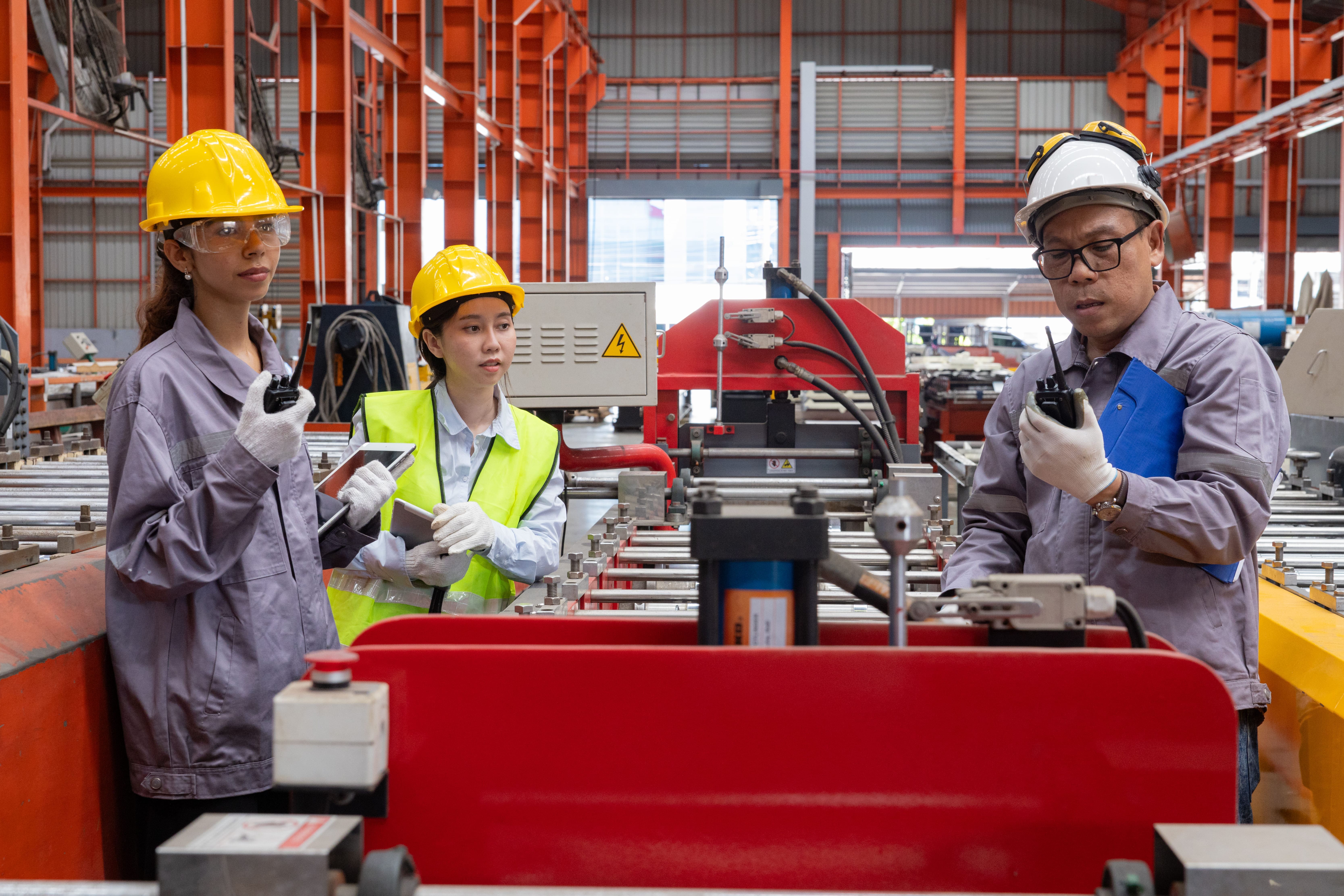 Trained operators running equipment on a fully operational factory assembly line