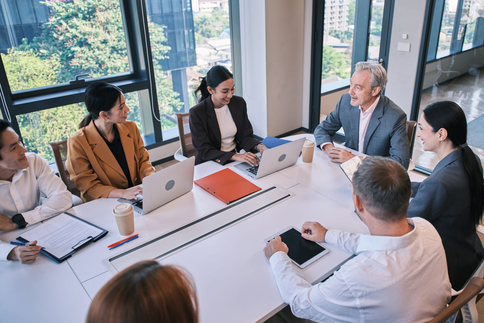 Corporate leadership team discussing confidential workforce transition planning around a boardroom table