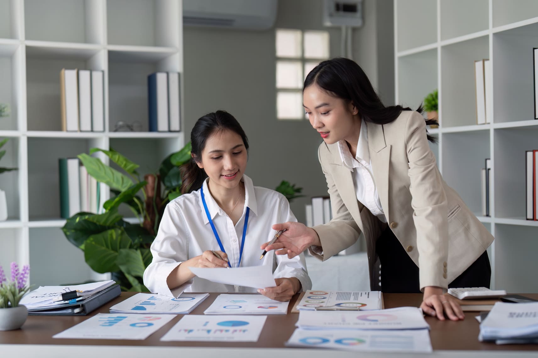 HR administrator guiding an employee through transition paperwork and company forms