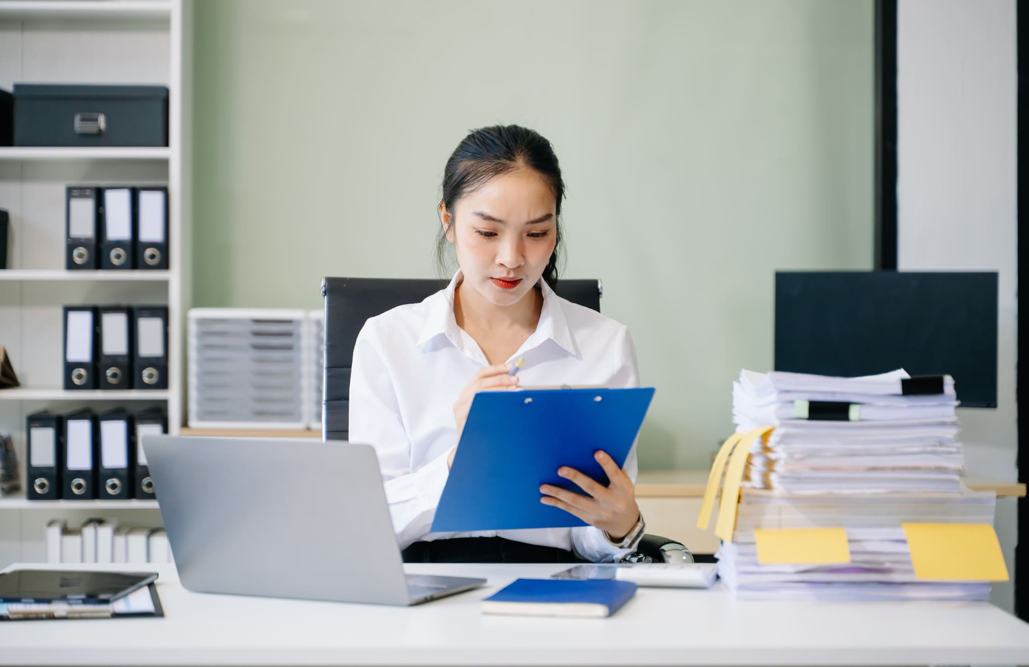 HR professional organizing employment contracts and employee documentation files