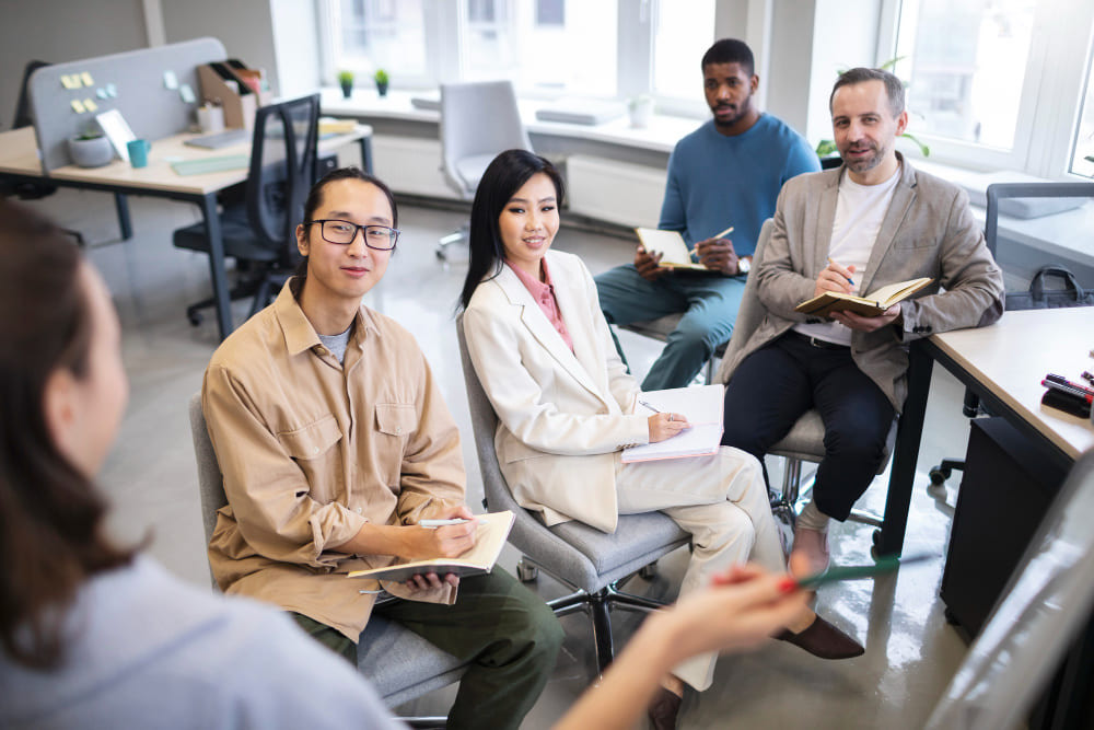 HR manager conducting a post-hiring discussion with a local employee in a modern office