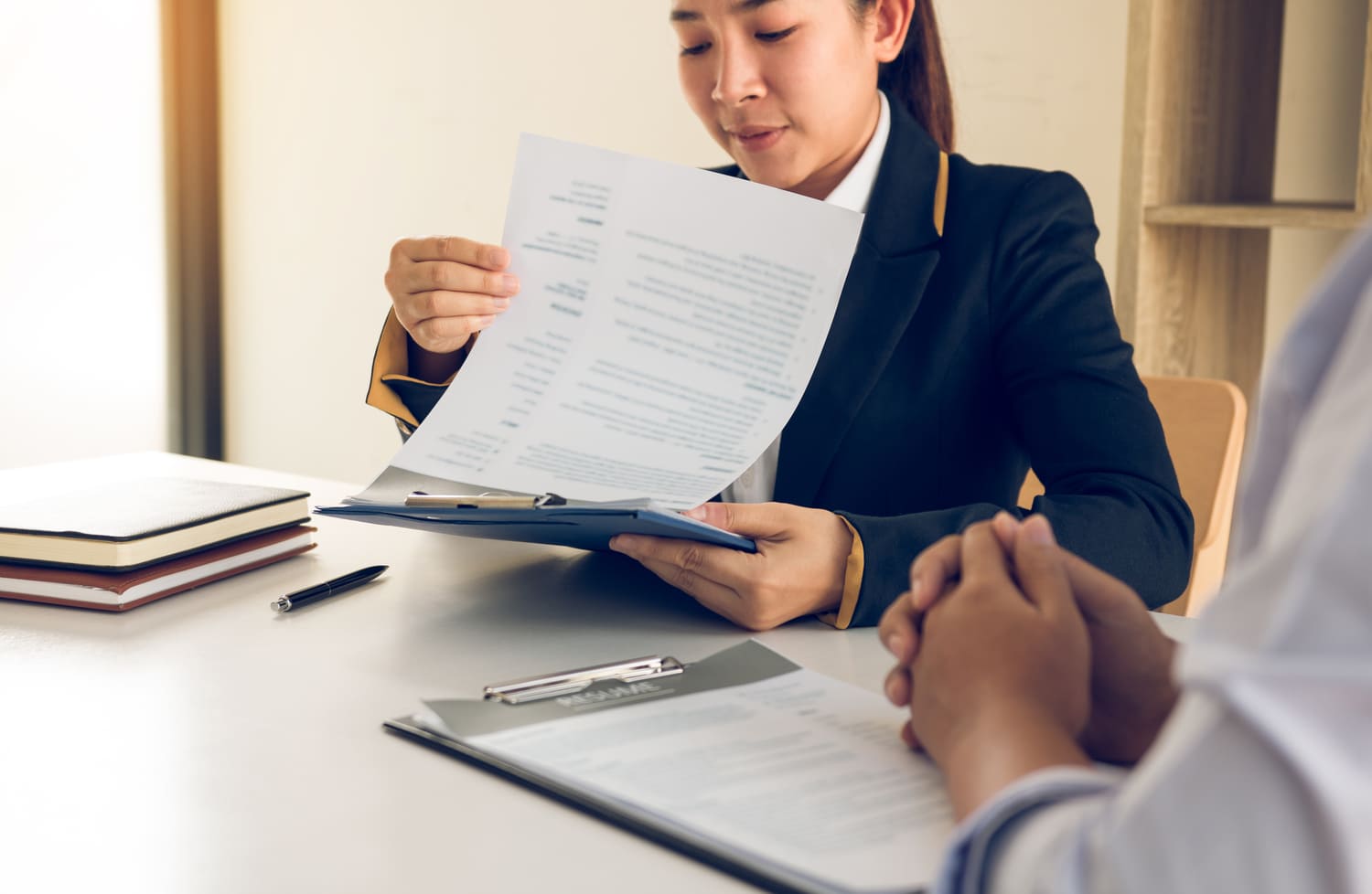 Expatriate employee reviewing employment contract and HR compliance documents with a specialist.